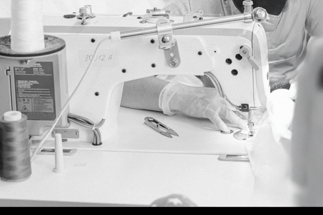 A woman sewing on a sewing machine