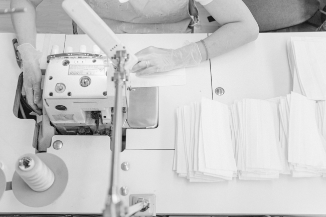 a womans sewing machine setup with fabrics