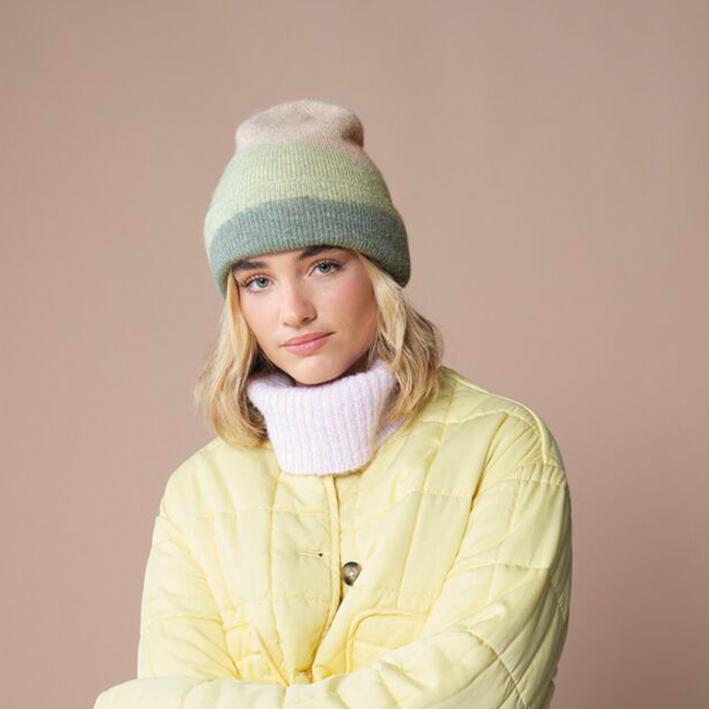 A woman styling a B532 Soft Wave Beanie
