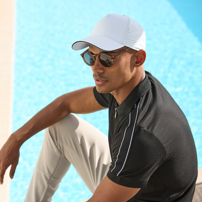 Beechfield Lifestyle Thumbnail. Man Wearing a cap by the pool