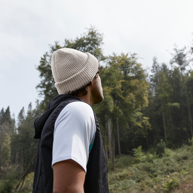 A man wearing a beanie in the woods